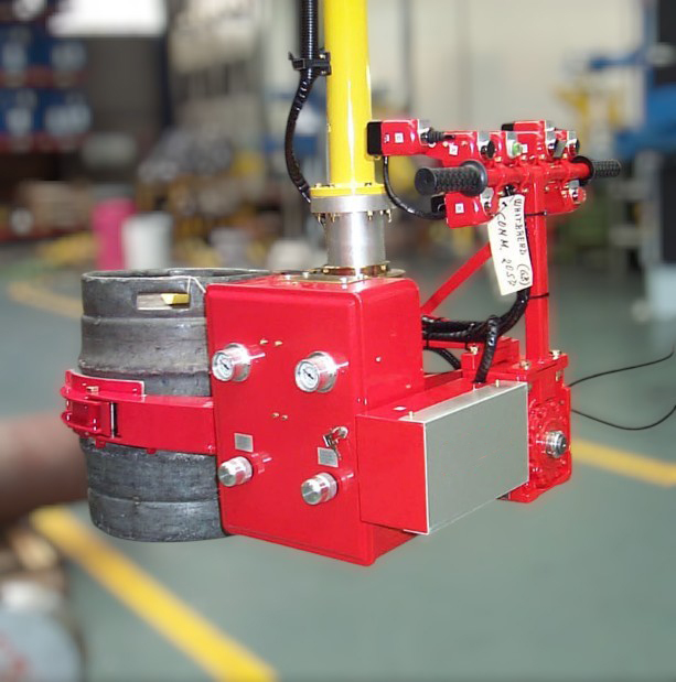 THEMA North America pneumatic manipulator installation in manufacturing facility demonstrating OSHA-compliant ergonomic engineering controls for musculoskeletal injury prevention and manual lifting hazard elimination