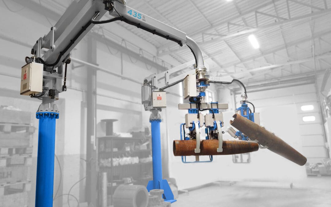 Operator guiding a pneumatic manipulator with a custom gripper while positioning an industrial component at a workstation
