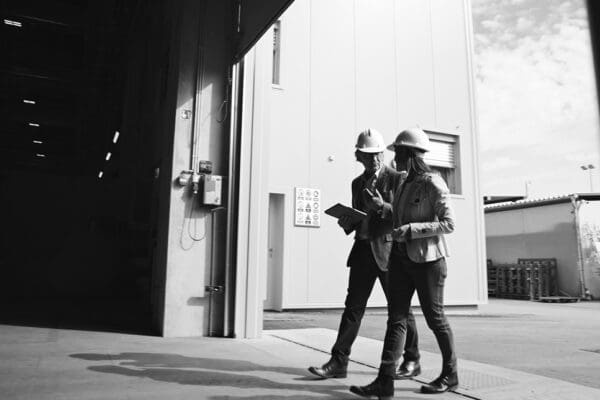 Manufacturing engineer and plant team reviewing operator reach, load path, and workstation layout during an automation readiness assessment