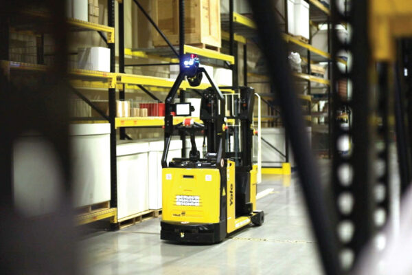Industrial worker utilizing zero gravity lifting manufacturing ergonomics to move heavy components with a pneumatic manipulator