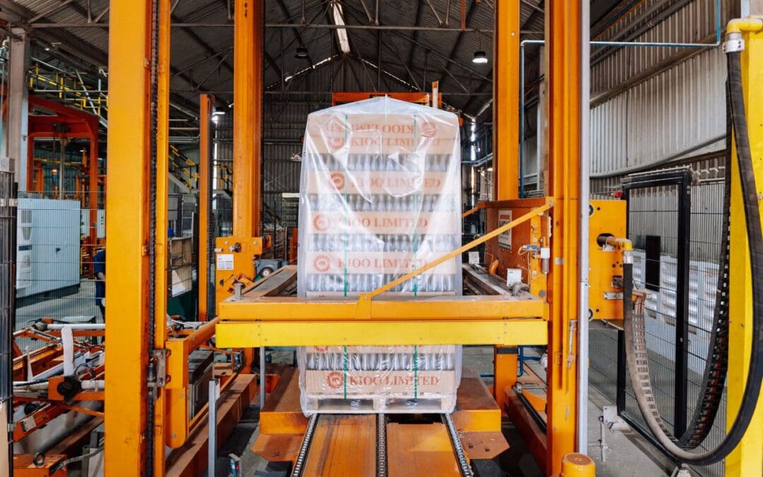 Warehouse worker operating an automatic pallet stretch wrapper machine